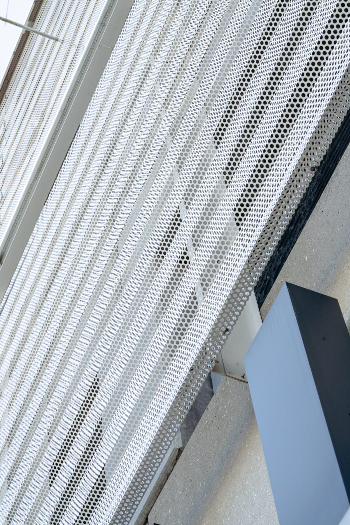 Perforated metal siding on Fashion Outlet building